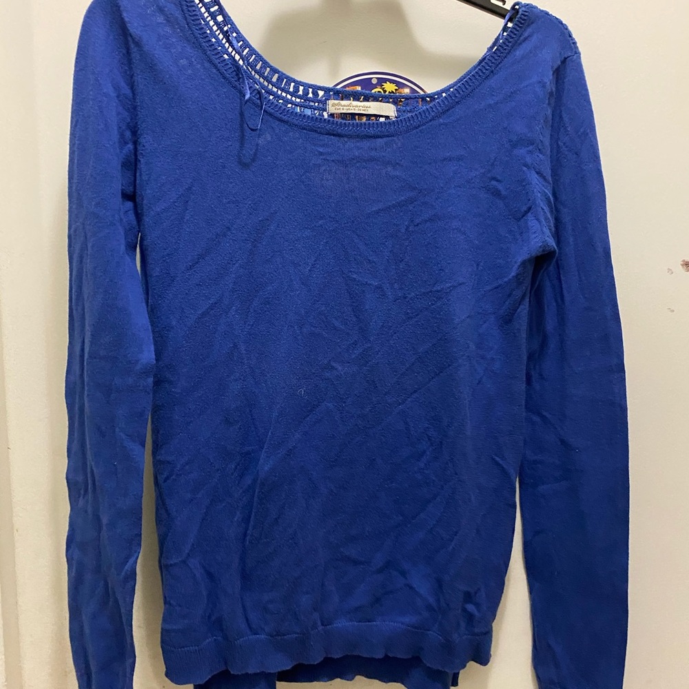blue sweater with open design on the back